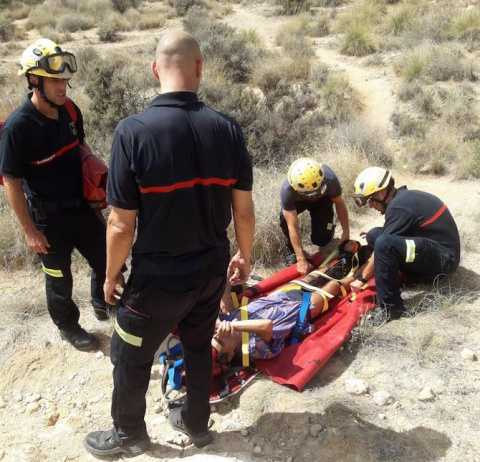 Los bomberos inmovilizan al herido en Cala Cantalar.